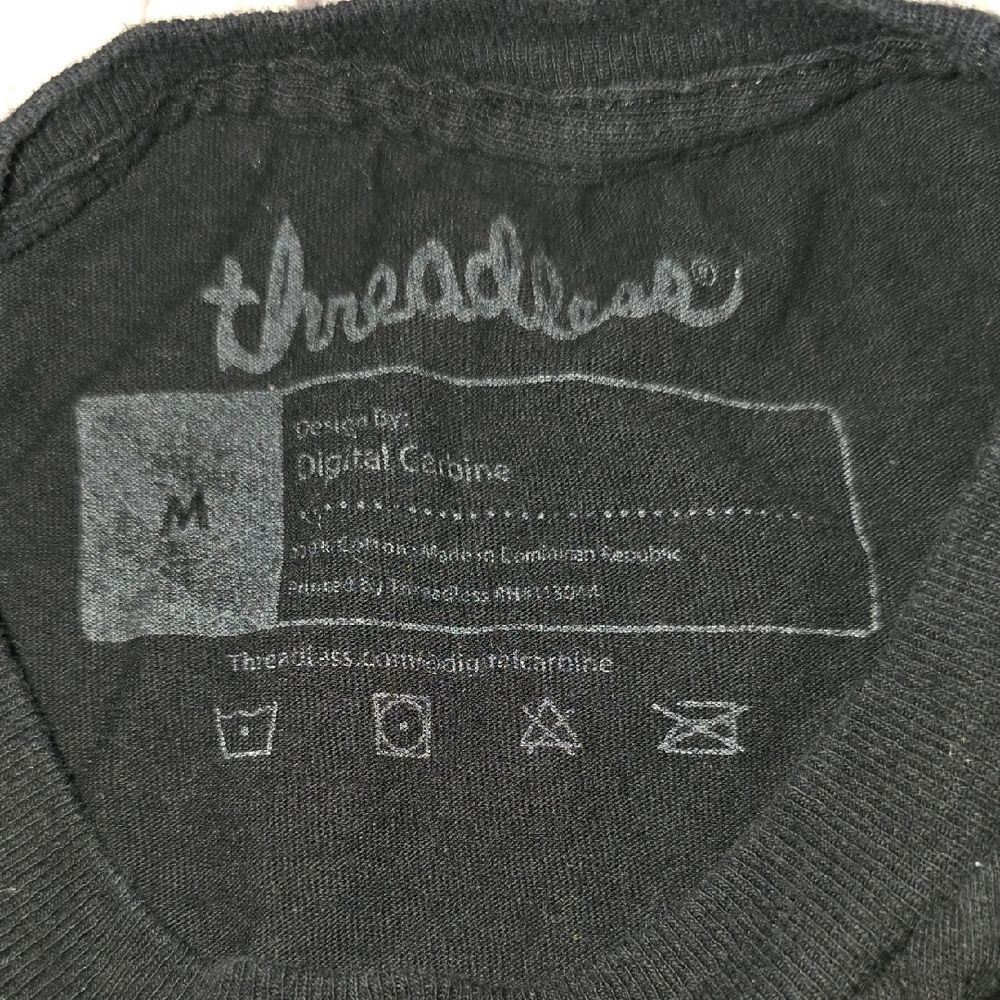 Black Tee with Yellow Smiley and Floral Design - Picture 2 of 3